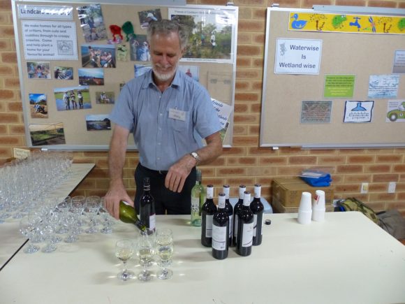 Dr Phil Ladd - Murdoch Branch Patron, pours the wine generously.